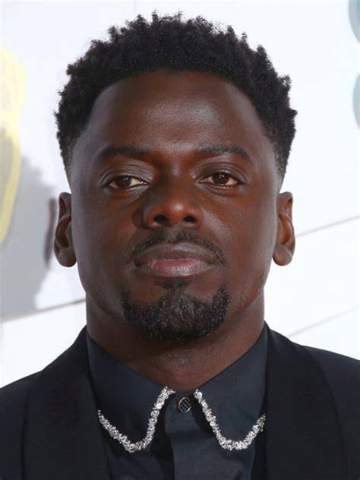 Daniel Kaluuya Daniel Kaluuya wearing a black suit jacket and white shirt