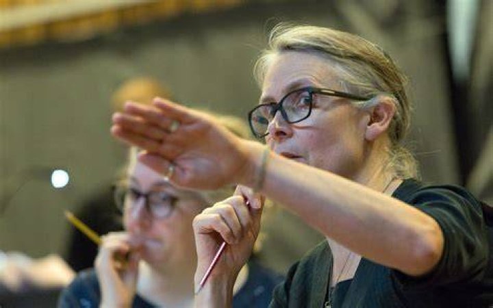 Katie Mitchell thrusting hand forward