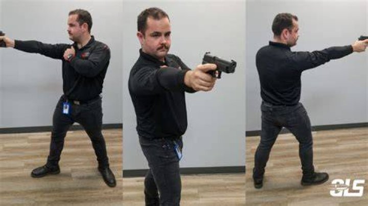 Officer pointing handgun forward