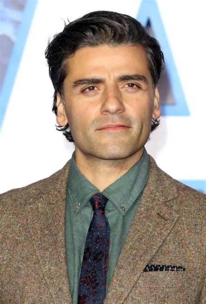 Oscar Isaac Oscar Isaac wearing a brown suit jacket with pink shirt
